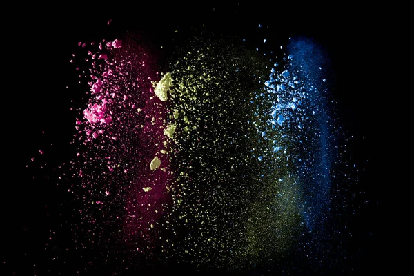 Abstract colorful dust particles textured background.Multicolored powder explosion on black background.