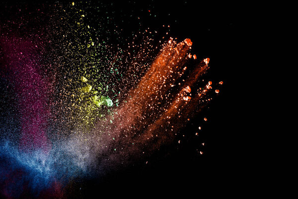 Abstract colorful dust particles textured background.Multicolored powder explosion on black background.