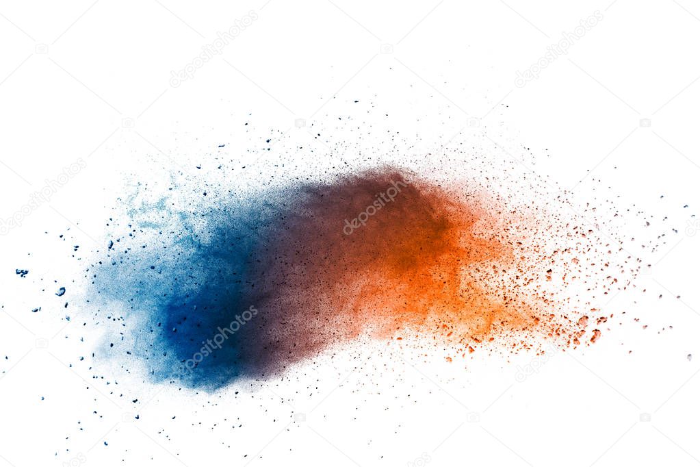 Abstract multi color powder explosion on white background.  Freeze motion of  dust  particles splashing.