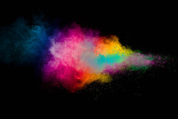 Explosion of colorful pigment powder on black background.Vibrant color dust particles textured background.