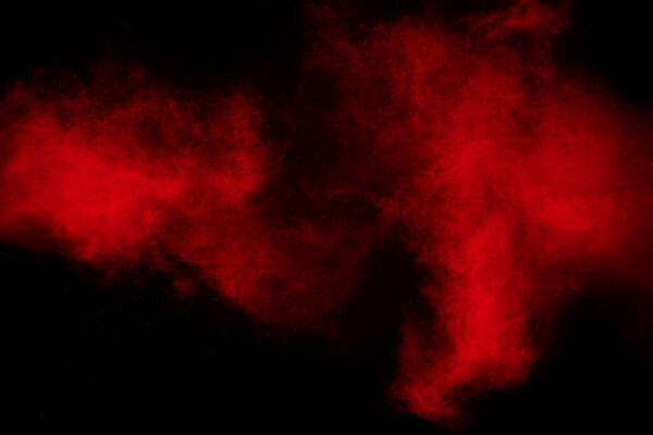 Freeze motion of red dust particles splashing.
