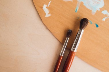 Petrol renk palet üzerinde ahşap masa portre üzerinde boya fırçaları