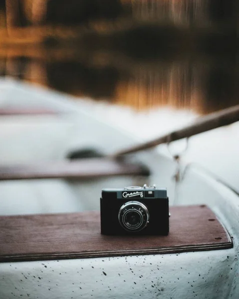 close up shot of vintage camera on boat seat