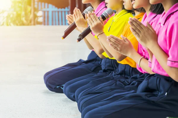 Buddhism is a major religion in the world, schoolchildren who lead prayer in school, sit together.