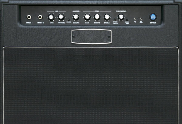 Close up of a guitar amplifier on a stage-Black and White grainy instagram style filtered image,fabric texture of loudspeaker mask,amplifier volume Controls,pattern of grille for creative background.