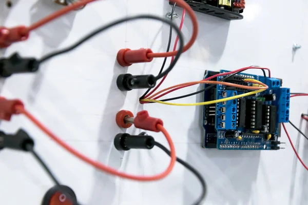 Red and black wires are the main current The plug is not tight enough to complete the power,Voltage switchboard with circuit breakers. Electrical background.