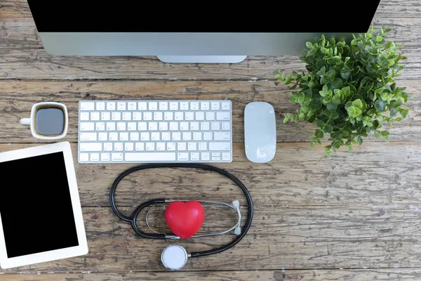 Health care is very important, using modern technology to check health, stethoscope, red heart, computer,Tablet, coffee, top view.