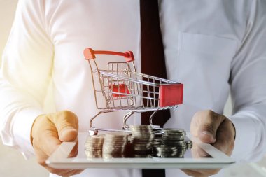 İş online kavramı. İşadamları sikke ve tramvay ile lots bir tabloid düzenliyoruz. Dizüstü bilgisayarda kolay E-ticaret Web sitesi Online alışveriş. 