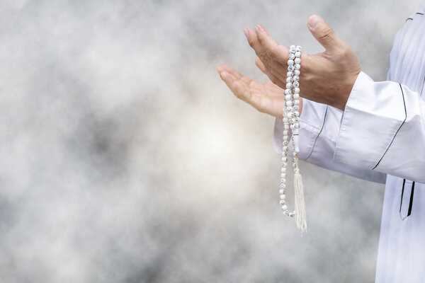 Religious muslim man praying inside the mosque,Men are praying their God Of Islam,Put the pure white dress,Hold hands to the front. Faith in Islamic.