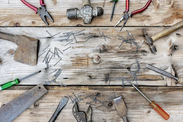 Collection of vintage woodworking tools on a rough workbench and blank copy space: carpentry, craftsmanship and handwork concept, flat lay. top view retro woodworking tools header.