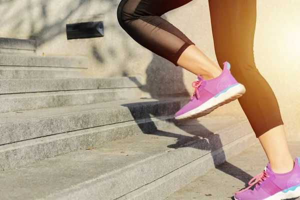 Fitness sport concept, young woman running up the stairs.