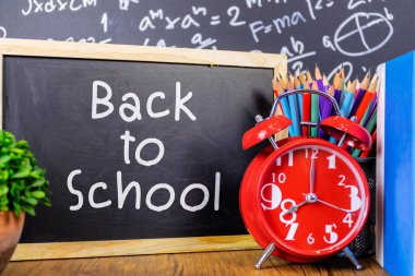 Okuldaki yazı tahtasına beyaz tebeşirle çizilmiş okul ögeleri ve ögeleri ile birlikte geri dön.