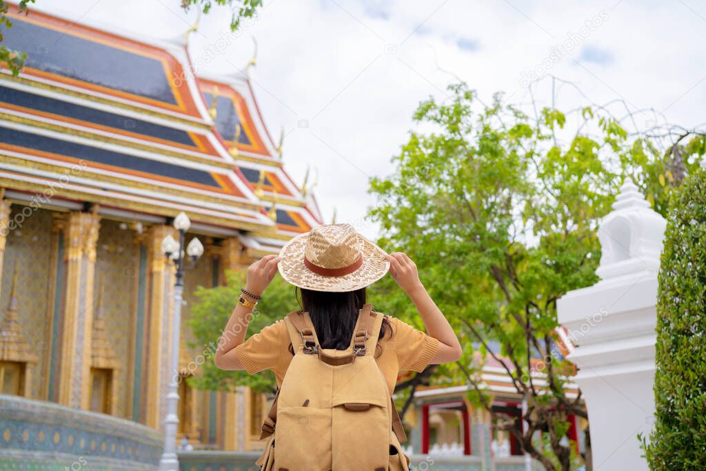 Asian female tourists traveling and visiting Thai temples in Bangkok, Thailand
