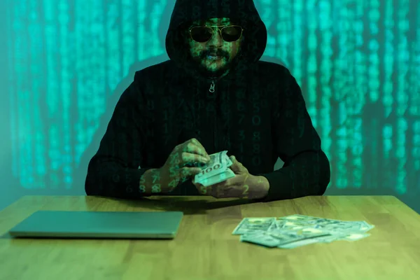 Data theft concept. A person looking at the computer screen with a worried expression. A stack of dollar bills, symbolizing the financial losses that can result from data theft.