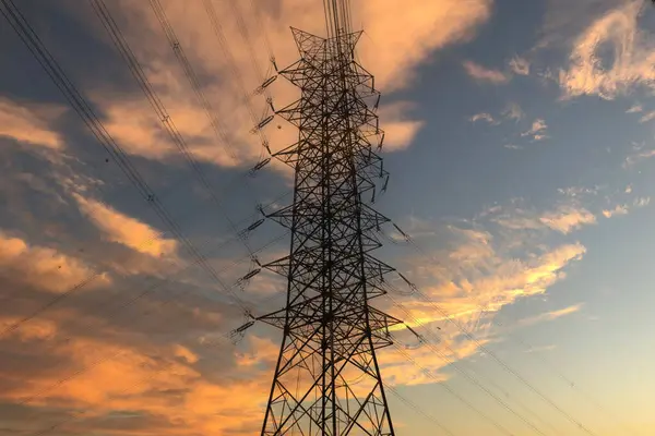 High-voltage power lines, high voltage electric transmission. High voltage electric tower line pylon for distribution of electricity from power stations to customers through national power grid.