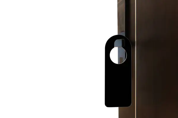A black door hanger is hanging on a white door. The door hanger is smooth and has a beveled edge. The door hanger has a silver hook that is used to hang it over the door knob. Clipping path.