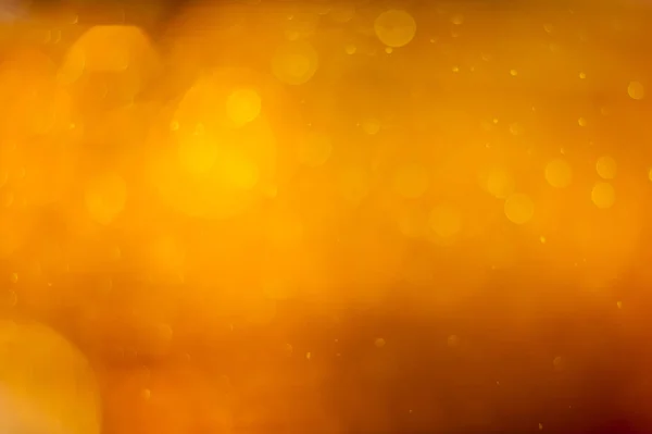 Golden orange bokeh or luxurious glitter lights festive background