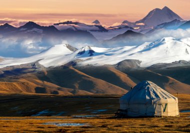 Yurt with mountains on background in Central Asian clipart