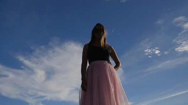 Fashion lifestyle portrait of young woman in tulle skirt