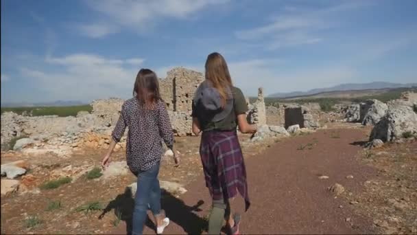 Two young girls exploring ancient city Lyrboton, Turkey Royalty Free Stock Footage