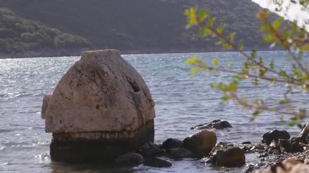 Broken ancient crypt stands in the water near sea shore in Kekova — Stock Video