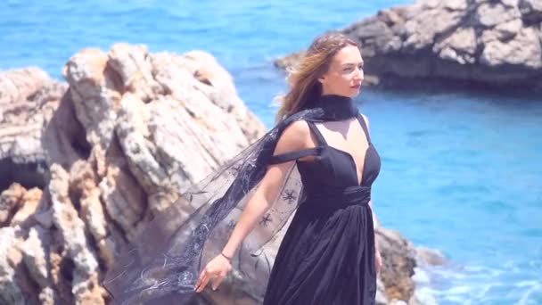 Schöne Frau mit schwarzem Schal im eleganten schwarzen Kleid — Stockvideo