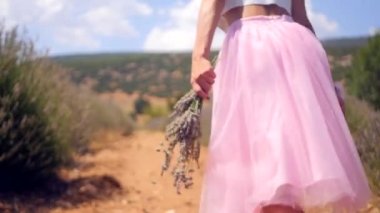 Womans hand holding lavender flowers and runs