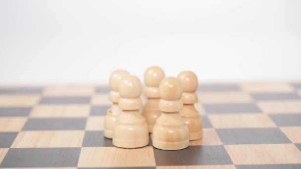 Brown queen figure take down pawns — Stock Video