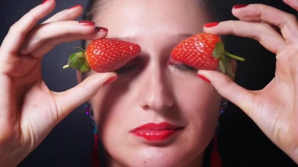 Portrait of young woman with red eyes and lips — Stock Video