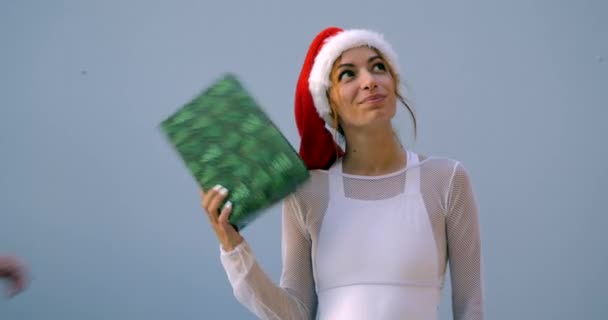 Young woman in Christmas hat in swimsuit — Stock Video