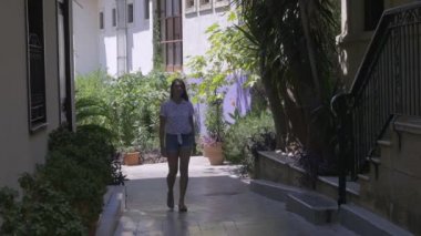 Young woman walking down old city street