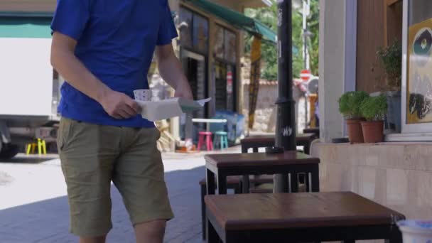 Young man sitting in a traditional asian cafe — Stok video