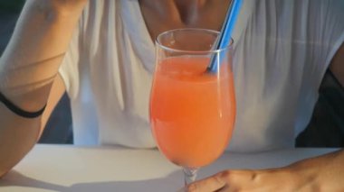 Woman drinking Refreshing orange cocktail