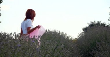 Young woman walking in the lavanda field