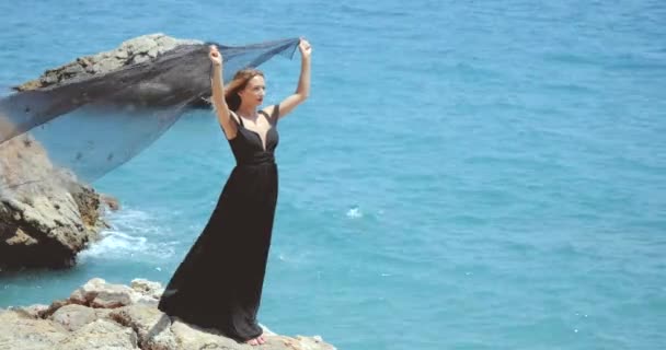 Beautiful woman with black scarf in elegant black dress — Stock Video