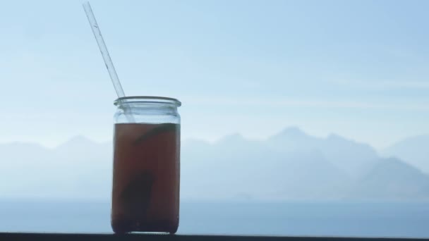 Fresh mix fruit juice in glass cup on the balcony — Stock Video