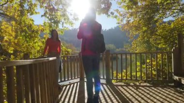 Young women takes a picture on the pier