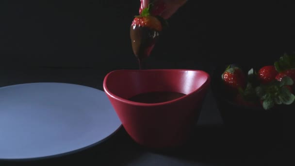 Dipping strawberry into chocolate mixture — Stock Video