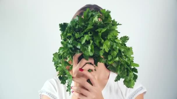 Portrait of a beautiful happy young woman with a bouquet of fresh parsley — Stock Video