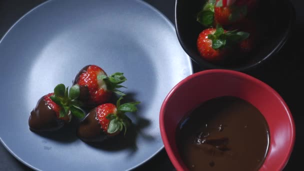 Dipping strawberry into chocolate mixture — Stock Video