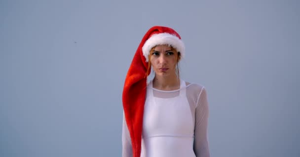 Young woman in Christmas hat in swimsuit — Stock Video