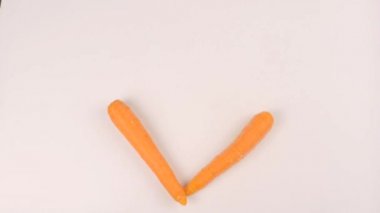 Woman puts carrots in the shape of a heart