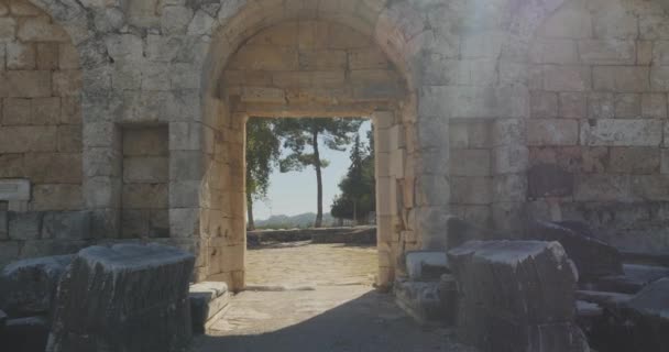 Walking through ancient arch in the wall in Ancient city Perge, open air antique historical museum — Stock Video