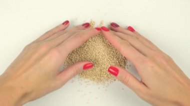 Womans hands forming heart from quinoa seeds