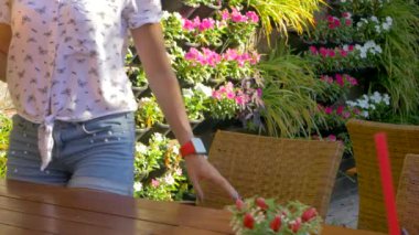 Young woman sitting at the table with coconut drink