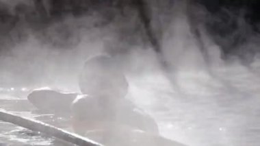 Woman in hot spring geothermal pool