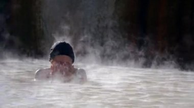 Woman in hot spring geothermal pool