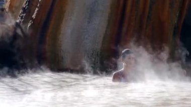 Woman in hot spring geothermal pool