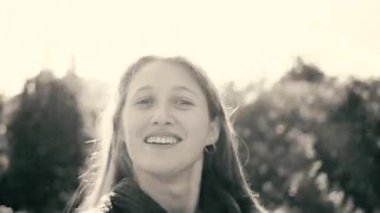 Point-of-view shot of woman spinning around in the garden in grey colors