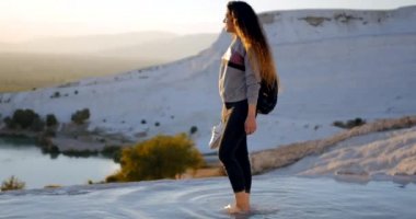 Young woman walking in Pamukkale terraces